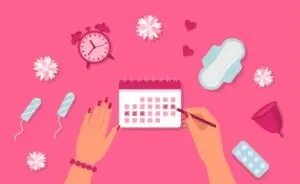 clock, calendar, tampons and pads on pink background - a period concept