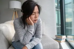 Sad Asian mature woman lonely at home