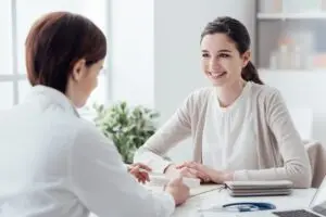 woman smiling and talking to doctor