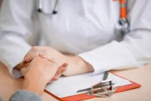 Doctor holding patient's hand