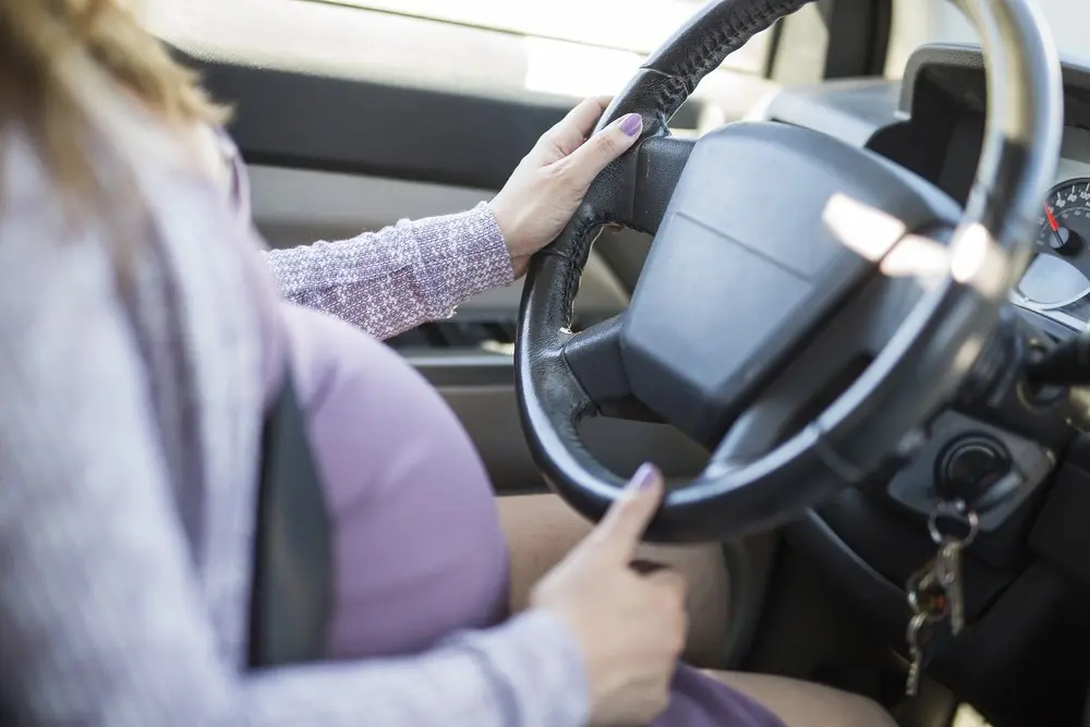 pregnant woman driving.