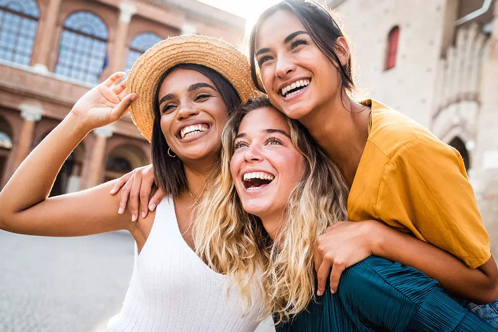 three happy young woman smilling