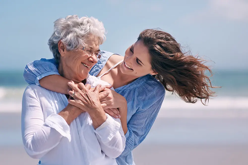 elderly woman and her daughter at the beach